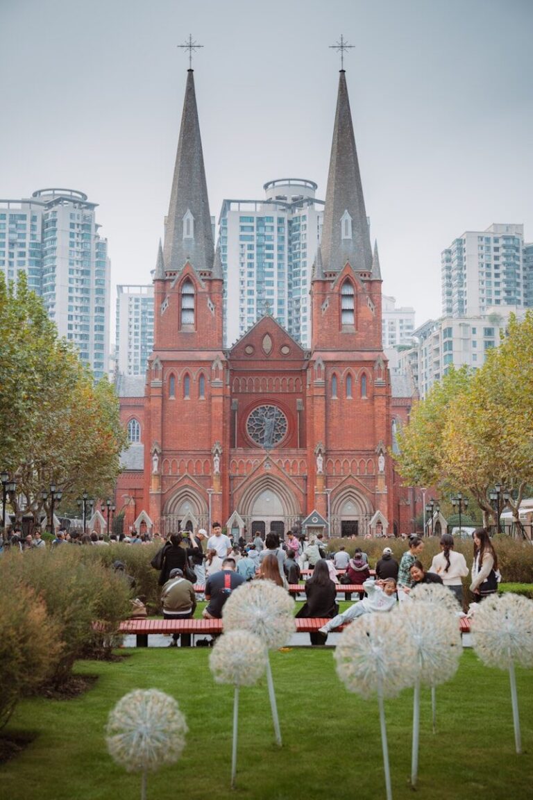 People gathered in front of a historic brick church.